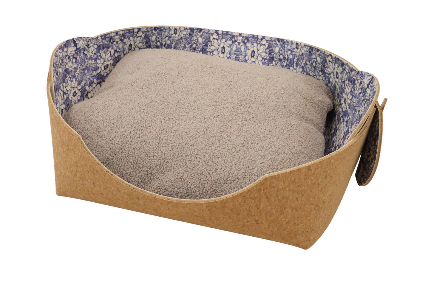 Cozy pet bed made of cork with raised sides and a blue flower pattern cushion inside, designed for dogs and cats to sleep comfortably