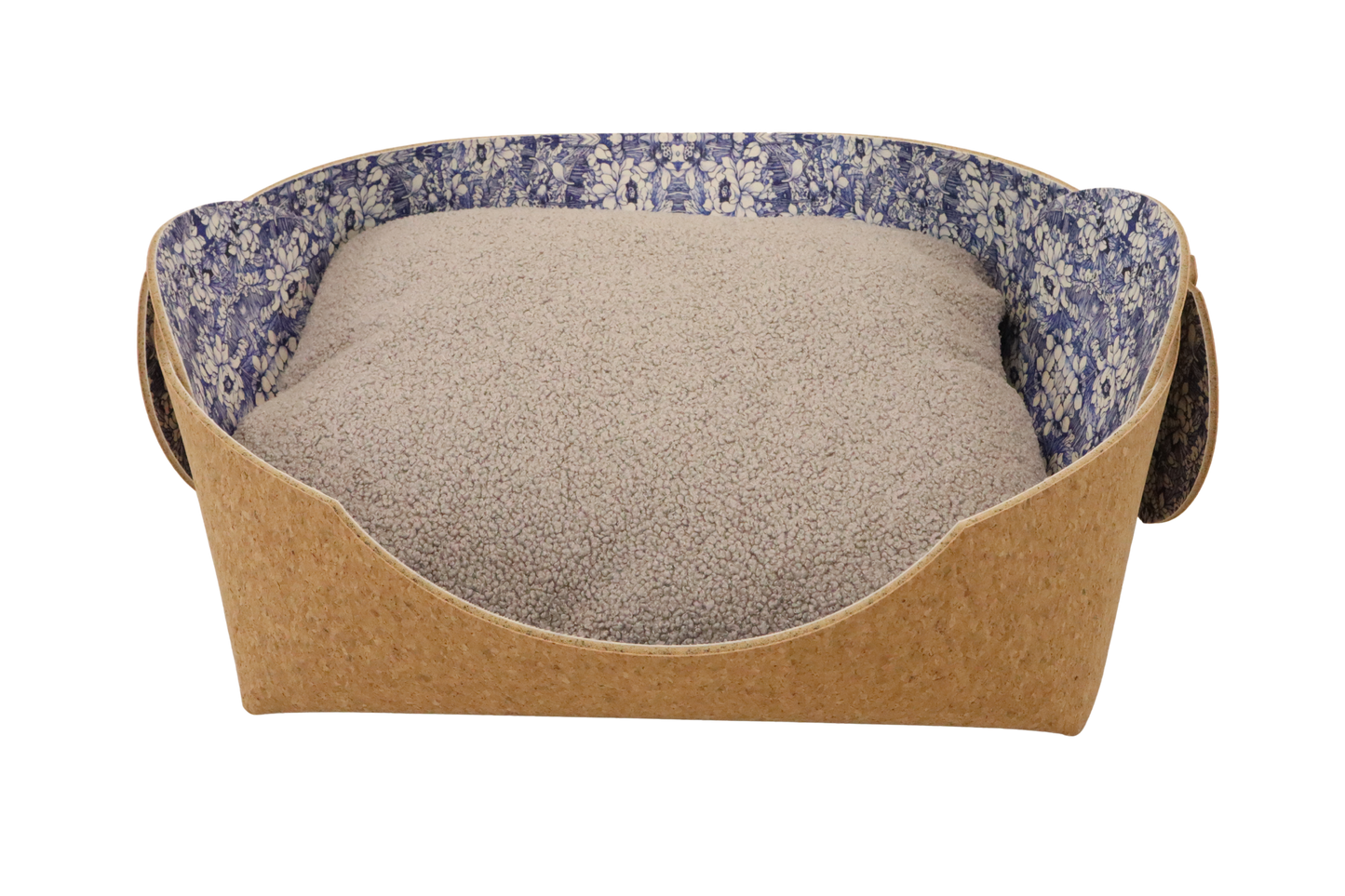 Cozy pet bed made of cork with raised sides and a blue flower pattern cushion inside, designed for dogs and cats to sleep comfortably