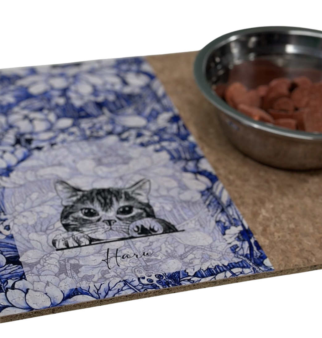 Cat-themed mat with a bowl of cat food on a white background