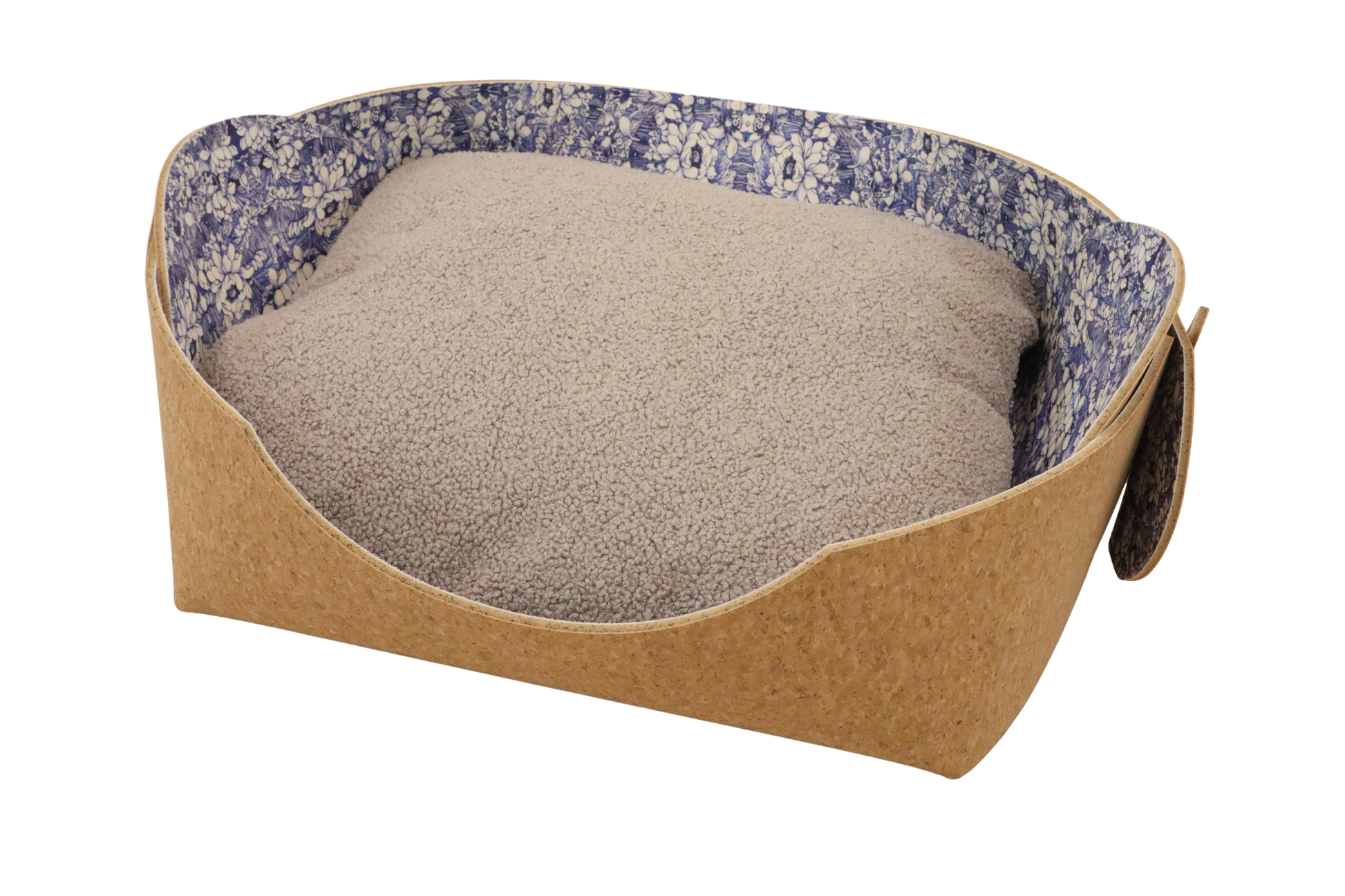 Cozy pet bed made of cork with raised sides and a blue flower pattern cushion inside, designed for dogs and cats to sleep comfortably