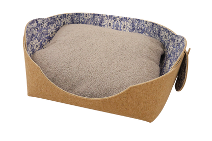 Cozy pet bed made of cork with raised sides and a blue flower pattern cushion inside, designed for dogs and cats to sleep comfortably