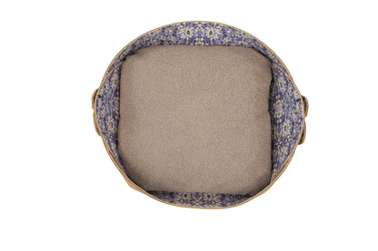 Round cushion with floral-patterned outer cover and beige inner filling on a white background