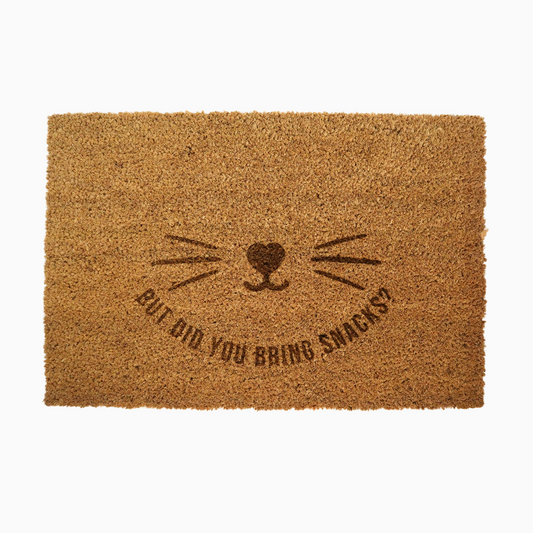 Doormat with cat face design and text 'But did you bring snacks?' on a white background
