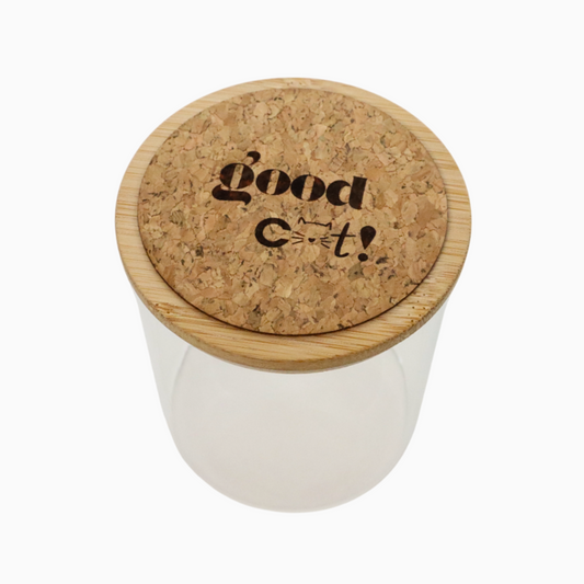 Food container for cats, with a cork lid that has 'Good C**t!' engraved on it, on a white background.