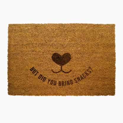 Doormat with heart design and text 'But did you bring snacks?' on a white background, perfect for dog lovers