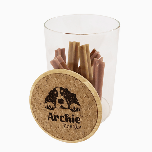 Food container with dog treats and cork lid featuring a customizable dog illustration and name on a white background, perfect for dog lovers