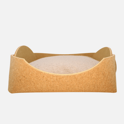 Cozy pet bed made of cork with raised sides and a soft beige cushion inside, designed for dogs and cats to sleep comfortably