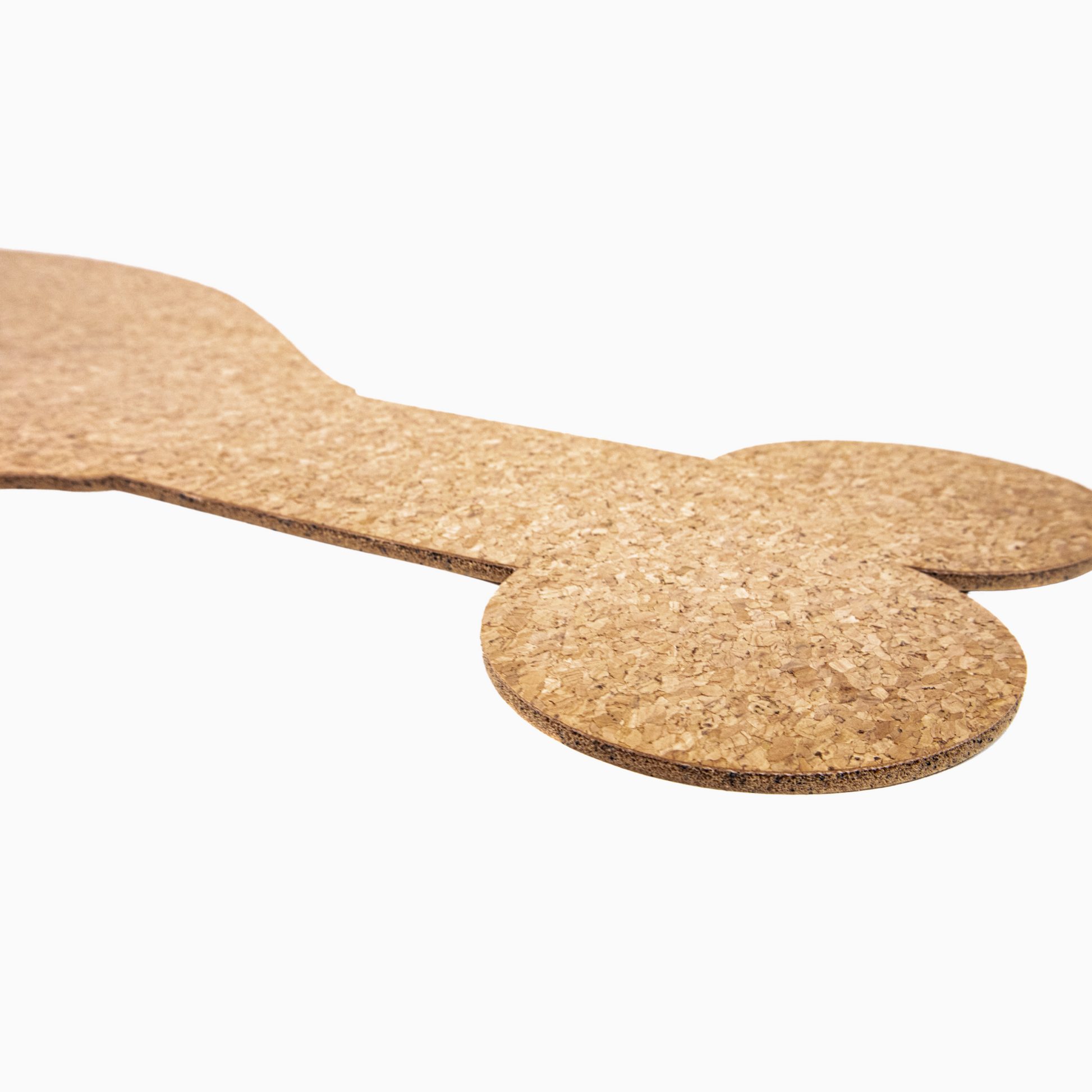 Cork mat shaped like a dog bone on a white background