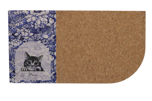 Cork mat with floral border and cat illustration on a white background
